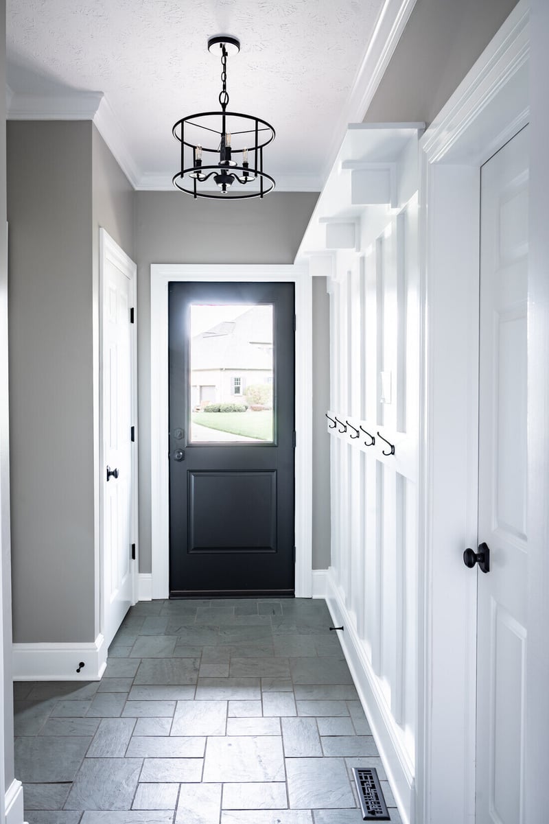 Mudroom breezeway renovation with built-in hooks in South Bend by Peacock & Company