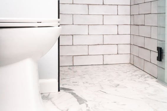 Curbless walk-in shower in bathroom remodel with subway tiling