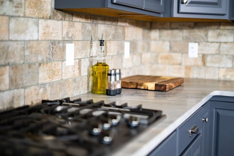 Kitchen countertop with cooktop and blue cabinetry