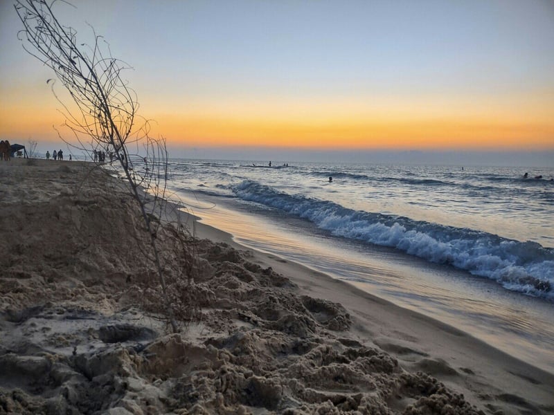 New Buffalo, MI public beach view at sunset with waves crashing at shore