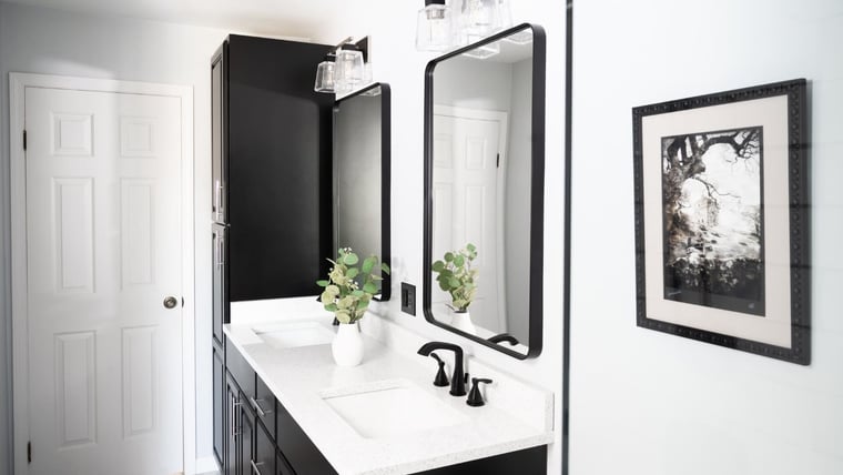 Marble countertops with double vanity and mirrors in bathroom remodel