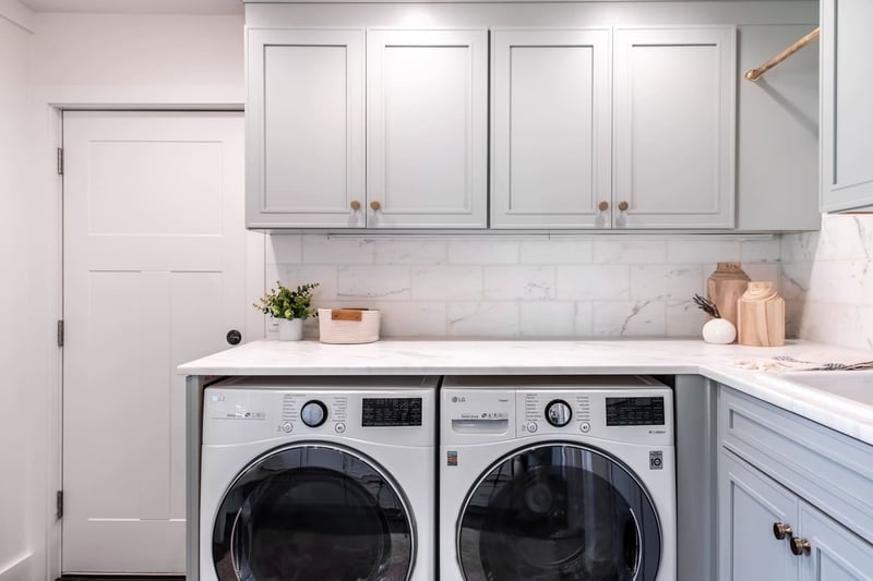 Mmudroom renovation with washer and dryer beneath custom cabinetry
