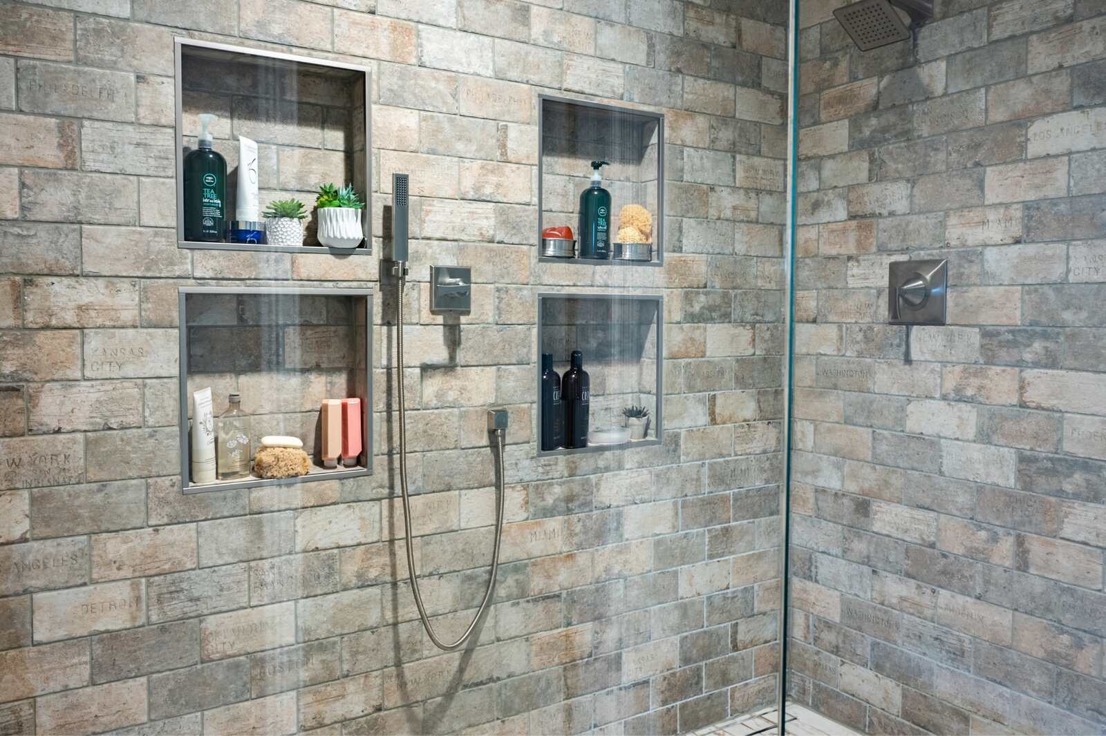 Rustic bathroom with stone tiling four shower niche