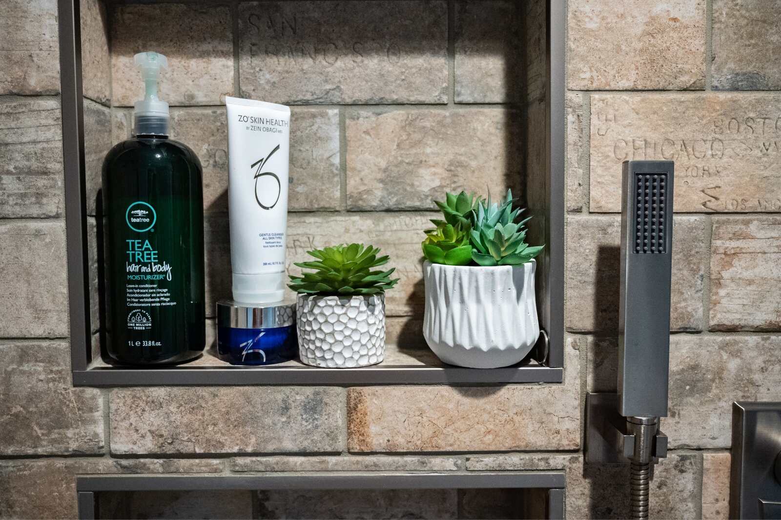 rustic bathroom with stone tiling shower niche