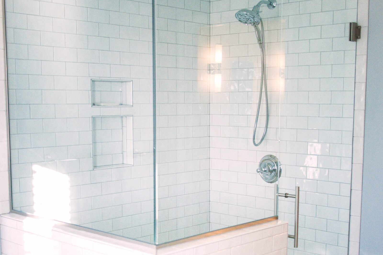 white tiling in shower with glass door