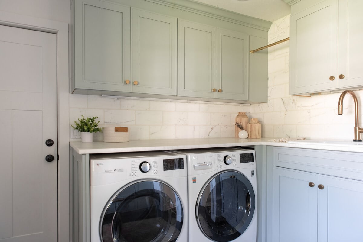 Mudroom addition near South Bend, Indiana with farmhouse style cabinetry and brass fixtures 