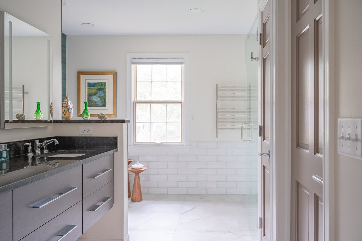 View from the doorway of bathroom remodel in South Bend by Peacock & Co. showing floating vanity and large format tile